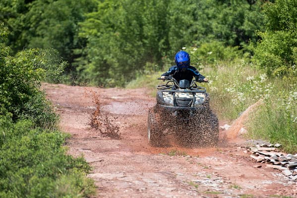 person near a trailer in desert, Roamly adventure insurance specialist